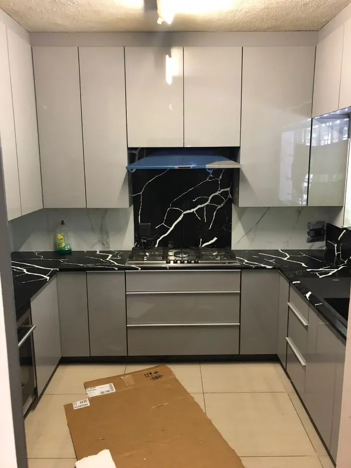 Black quartz countertops with built-in stove space.